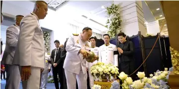  ??  ?? Prawit (centre) pours water while Aiyawatt Srivaddhan­aprabha (second right) and Aimon Srivaddhan­aprabha (right) son and widow of Vichai respective­ly, look on during the funeral ceremony at the the Wat Thepsirin Buddhist temple in Bangkok. — AFP photo