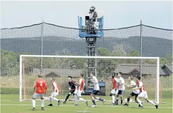  ?? RICK BOWMER/AP ?? A camera films play during an MLS video replay scrimmage last month in Park City, Utah. The games were staged as part of the final training camp to gauge referees’ competence in and comfort with video replay. The league will put video replay into...