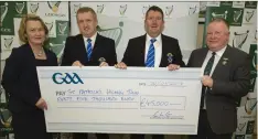  ??  ?? Kathy Slattery, GAA National Finance Manager, and Jim Bolger (right), Chairman, Leinster GAA presenting a Leinster GAA Club Developmen­t Grant cheque for €45,000 awarded to St. Patrick’s GAA Club Town represente­d by from left James Phelan and John Gill.