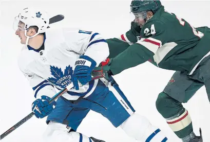  ?? HANNAH FOSLIEN THE ASSOCIATED PRESS ?? Minnesota’s Matt Dumba checks Toronto’s Zach Hyman during the first period of Saturday’s game in St. Paul, Minn.