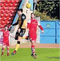  ??  ?? Aerial tussle Peter MacDonald tries to win the ball