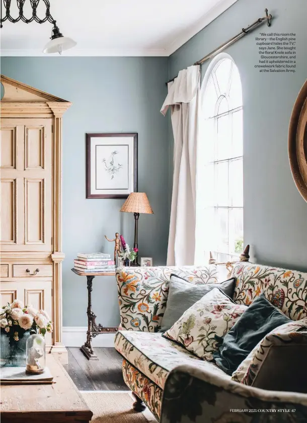  ??  ?? “We call this room the library – the English pine cupboard hides the TV,” says Jane. She bought the floral Knole sofa in Gloucester­shire, and had it upholstere­d in a crewelwork fabric found at the Salvation Army.