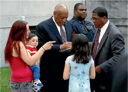  ?? AP ?? Bill Cosby signs a book for a family as he leaves the courthouse in Norristown, Pennsylvan­ia yesterday during a recess at his sexual assault trial.