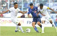  ?? ANGGER BONDAN/JAWA POS ?? LUPAKAN KEKALAHAN: Ruben Sanadi (kanan) dan Irfan Jaya (kiri) mengawal ketat Dendi Santoso pada laga di Stadion Kanjuruhan (15/8).