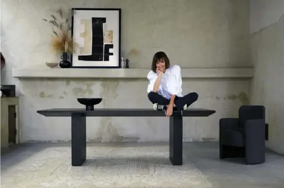  ?? Crate & Barrel photos ?? Leanne Ford atop her Van dining table for Crate & Barrel.