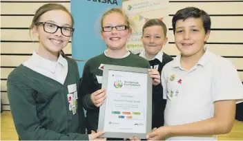  ??  ?? Pupils from Woodston Primary School receive their Peterborou­gh Eco Framework cerificate