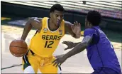  ?? TONY GUTIERREZ — THE ASSOCIATED PRESS ?? Baylor’s Jared Butler (12) works against Stephen F. Austin’s DeAndre Heckard in Waco, Texas on Wednesday.