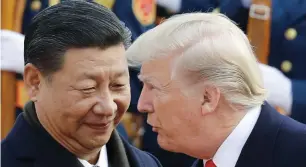  ?? — AP ?? Donald Trump talks to Chinese President Xi Jinping in Beijing. Trump’s heaviest tariffs on Chinese goods have yet to take effect. Trump has not carried out his other dire warnings on trade as well.