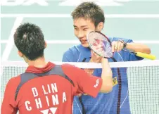  ??  ?? Chong Wei is congratula­ted by Lin Dan after their men’s singles semi-final in the Japan Open badminton tournament in Tokyo in this September 15, 2007 file photo.