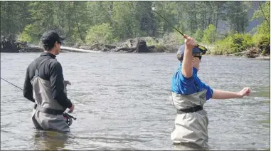  ??  ?? Fly fishing on the freshwater rivers is one of the options at King Pacific Lodge, another is ocean trolling. Eightyearo­ld Zev Kaufman shows off his catch at left.