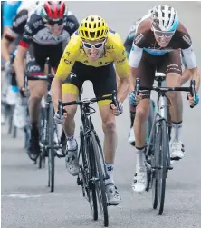  ??  ?? Britain’s Geraint Thomas, left, sprints with France’s Romain Bardet, toward the finish line in Laruns, France.