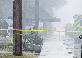  ?? CATHIE COWARD THE HAMILTON SPECTATOR ?? A tent covers evidence markers in front of a townhouse on on Caledon Street where the SIU is investigat­ing the police shooting of a youth in the townhouse complex Tuesday afternoon.