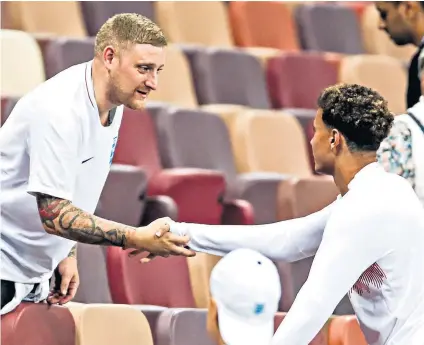  ??  ?? Thanks for the ride: A fan shakes hands with midfielder Dele Alli after England’s World Cup semi-final defeat by Croatia