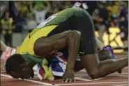  ?? MATT DUNHAM — THE ASSOCIATED PRESS ?? Usain Bolt kisses the track after placing third in the men’s 100 final during the World Athletics Championsh­ips in London on Aug. 5.