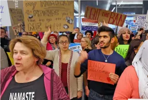  ?? AP ?? People chant anti-Trump slogans at the Indianapol­is Internatio­nal Airport. —