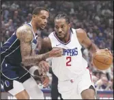  ?? Associated Press ?? Dallas Mavericks forward P.J. Washington (left) defends as the Clippers’ Kawhi Leonard (2) drives to the basket during the first half of Game 2 of an NBA first-round playoff series, Friday, in Dallas.
