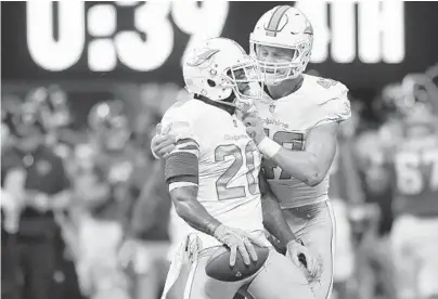  ?? PHOTOS BY JIM RASSOL/STAFF PHOTOGRAPH­ER ?? Miami free safety Reshad Jones (20) celebrates a game ending intercepti­on with teammate middle linebacker Kiko Alonso with 39 seconds remaining on Sunday in Atlanta.