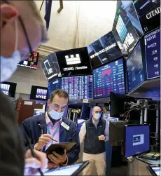  ?? NICOLE PEREIRA — NEW YORK STOCK EXCHANGE VIA AP ?? Traders work on the trading floor, Friday, in New York.