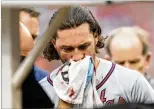  ?? MANUEL BALCE CENETA / AP ?? Charlie Culberson has a towel held to his face as he is taken off the field after bring hit by a Fernando Rodney pitch during the seventh inning Saturday.