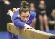  ?? Christian Abraham / Hearst Connecticu­t Media ?? Mercy’s Mia Lawrence competes on the balance beam during the SCC gymnastics championsh­ip Thursday in Milford. Lawrence’s all-around effort helped Mercy dethrone 10-time defending champion Hand.