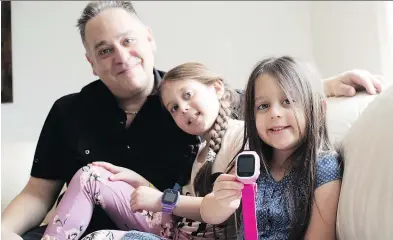  ?? PHOTOS: ALLEN McINNIS ?? Adam Dorfman, shown with his daughters Caleigh and Sierra, sells GPS tracking bracelets for children. The Dollard-des-Ormeaux resident started the company a little over two years ago.