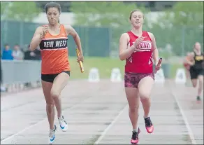  ??  ?? Nina Schultz, left, of the New Westminste­r Secondary School Hyacks runs her leg of the 4x100 relay this week at Swangard Stadium.