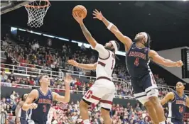  ?? TONY AVELAR AP ?? Stanford guard Jared Bynum drives to the basket against Arizona defenders.