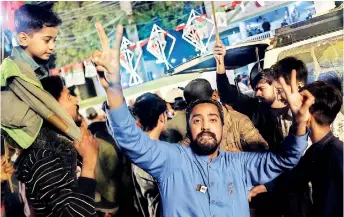 ?? ?? A supporter celebrates the victory of a candidate in Karachi on February 9, a day after Pakistan's national elections. (AFP)
