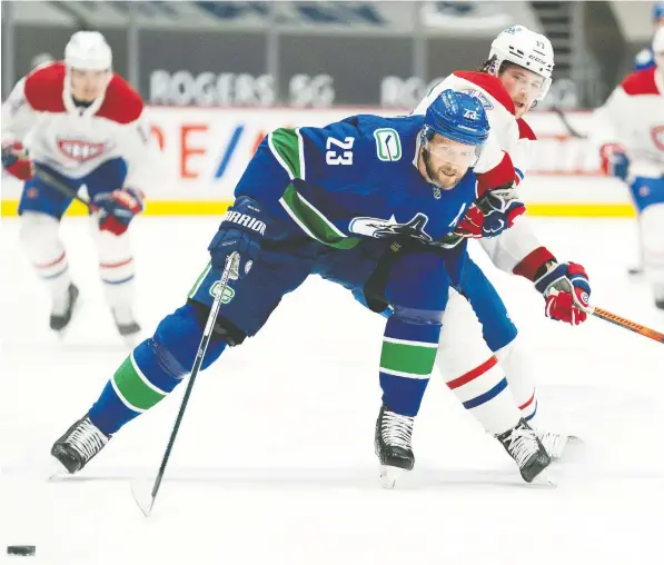  ?? — JONATHAN HAYWARD/CANADIAN PRESS FILES ?? Veteran blue-liner Alex Edler may no longer have the foot speed, but he still has the size and strength to deal with the likes of Montreal Canadiens power forward Josh Anderson.