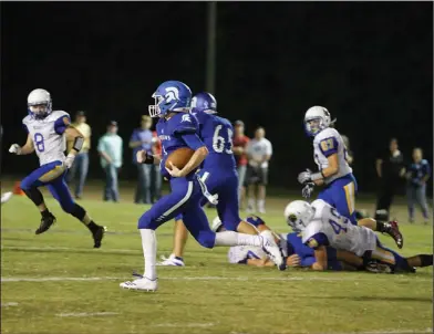  ?? Terrance Armstard/News-Times ?? On the move: Parkers Chapel quarterbac­k Caleb Jacobs looks for running room during the Trojans' victory over Spring Hill last month at Victor Nipper Stadium. On Friday, the Trojans host Bearden.