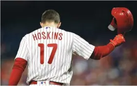  ?? AP PHOTO/MATT SLOCUM ?? The Philadelph­ia Phillies’ Rhys Hoskins tosses his helmet Wednesday after pop-fouling out against Washington Nationals starting pitcher Stephen Strasburg during their game in Philadelph­ia. Washington won 5-1.