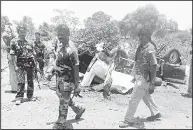  ??  ?? Indian security personnel walk past the debris of a police vehicle blown up by suspected Maoist rebels in Gadchiroli district, Maharashtr­a, India, May 11. Authoritie­s say leftist rebels detonated a land mine under the police vehicle and killed seven...