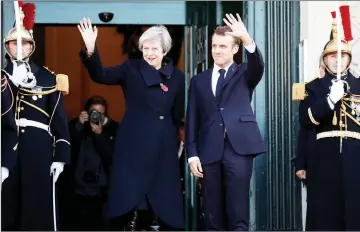  ??  ?? Macron and Britain’s Prime Minister Theresa May arrive for a meeting at the city hall in Albert, France as part of a World War One commemorat­ion tour.