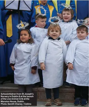  ??  ?? Schoolchil­dren from St Joseph’s Nursery in Dublin 8 at the launch of the Live Animal Crib at the Mansion House, Dublin. Photo: Gareth Chaney / Collins