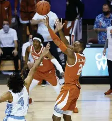  ?? AP ?? HE CALLED GAME: Matt Coleman III hit a stepback jumper to give Texas a win over UNC yesterday.