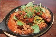  ??  ?? Full-bodied and filled with rich, glorious flavours, the grilled Portuguese chicken and dirty rice is a delight from start to finish.