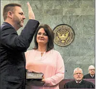  ?? Arkansas Democrat-Gazette/THOMAS METTHE ?? Cody Hiland takes his oath as U.S. attorney Friday at the federal courthouse in Little Rock as his wife, Jana, holds the Bible.