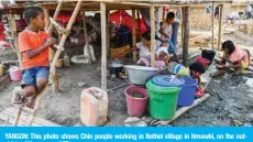  ??  ?? YANGON: This photo shows Chin people working in Bethel village in Hmawbi, on the outskirts of Yangon. — AFP