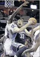  ??  ?? Grizzlies center Marc Gasol, who had 12 points and nine rebounds, is fouled as he drives to the basket against Bobcats power forward Bismack Biyombo during the second half Saturday night in Charlotte, N.C. The 8-1 Grizzlies won 94- 87. CHUCK BURTON...