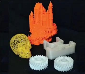  ?? PHOTOGRAPH­Y IAN STEWART ?? A wide range of items can be printed in 3D, including gears and an orange plastic castle.                                                   