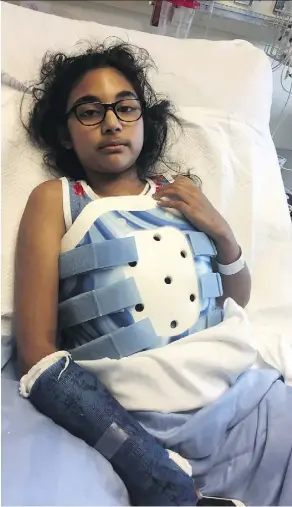  ?? THE CANADIAN PRESS ?? Mehak Minhas, 10, lies in her Alberta Children’s Hospital bed in Calgary on Thursday. The girl has been seeing a physiother­apist but it’s too soon to say how much mobility she may regain.