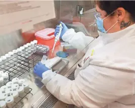  ??  ?? Gabriel works on student saliva samples. This is one of the first steps in the COVID-19 testing at Ohio State University’s COVID-19 testing lab in the Applied Microbiolo­gy Services Laboratory on campus.