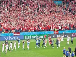  ?? REUTERS ?? Denmark players celebrate with fans after their Group B match against Russia at the Parken Stadium, Copenhagen, on Monday.