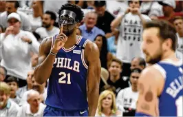  ?? ERIC ESPADA / GETTY IMAGES ?? 76ers center Joel Embiid reacts after hitting a 3-pointer against the Heat on Thursday. Embiid had 23 points and seven rebounds in his first playoff game.