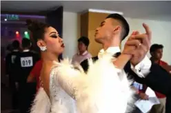  ??  ?? Vietnamís Vu Hoang Anh Minh (left) and Nguyen Truong Xuan practice backstage before competing in the dancesport event in Clark, Capas town.