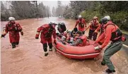  ?? Kent Porter/associated Press ?? Sonoma County firefighte­rs rescue the driver of a van whose vehicle stalled out in high water in Guernevill­e.