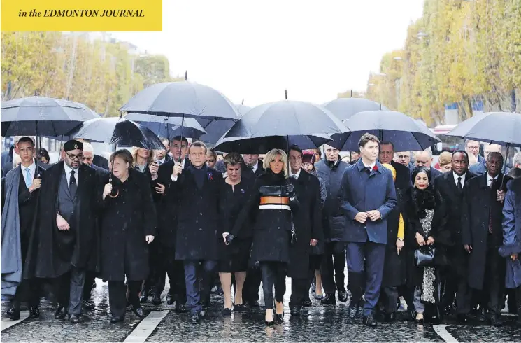  ?? LUDOVIC MARIN / POOL PHOTO VIA AP ?? In Paris Sunday, from left, Morocco’s Prince Moulay Hassan, Moroccan King Mohammed VI, German Chancellor Angela Merkel, French President Emmanuel Macron with wife Brigitte Macron, Prime Minister Justin Trudeau, Niger’s First Lady Lalla Malika Issoufou, President of Niger Mahamadou Issoufou and Republic of Guinea President Alpha Condé.
