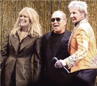  ?? RICHARD DREW AP ?? Designer Michael Kors, center, is joined by model Patti Hansen and Barry Manilow on stage after his collection was modeled Wednesday during Fashion Week in New York.