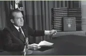  ?? ASSOCIATED PRESS ?? President Richard M. Nixon is shown pointing to the transcript­s of the White House tapes in 1974. Nixon resigned before the House could take up impeachmen­t.
