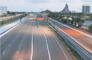  ?? STEPHEN M. DOWELL ORLANDO SENTINEL FILE PHOTO ?? The Interstate 4 — the eternally traffic- clogged gateway to the theme parks — wears a deserted look last March, one of the haunting images of the coronaviru­s pandemic in the U. S.